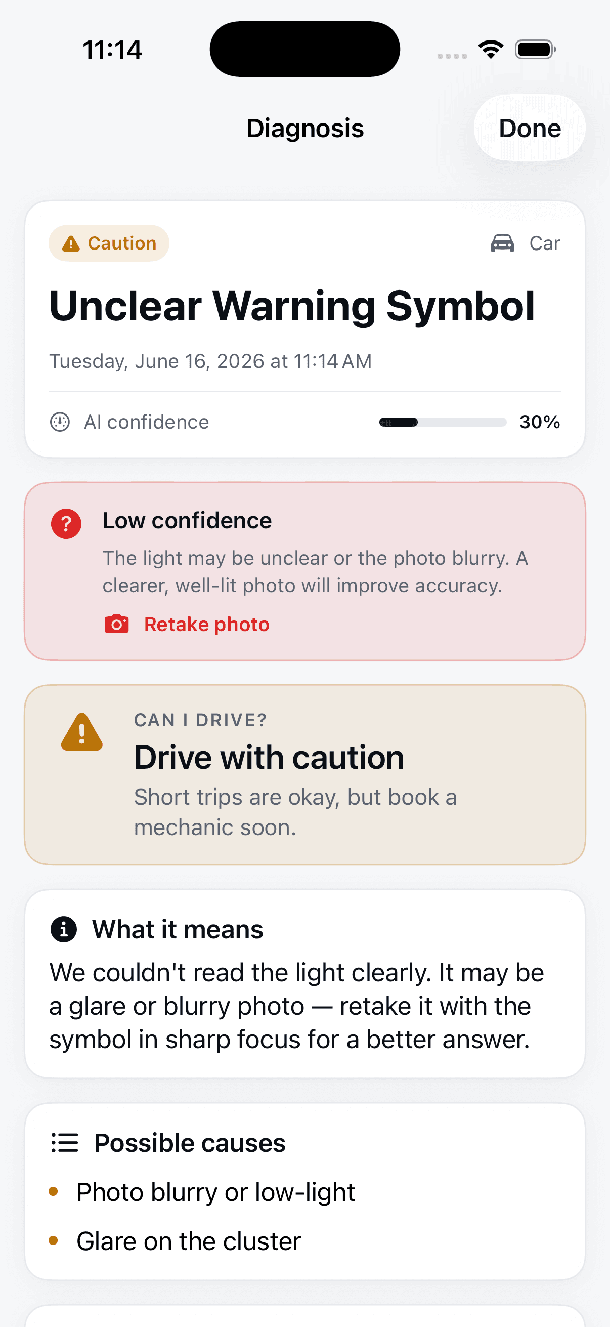 VehicleSense result flagged 'Low confidence' on an unclear warning symbol, offering a Retake photo button